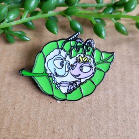A Bugs Life Enamel Pin Badge featuring Flik and Princess Atta on a heart shaped leaf.